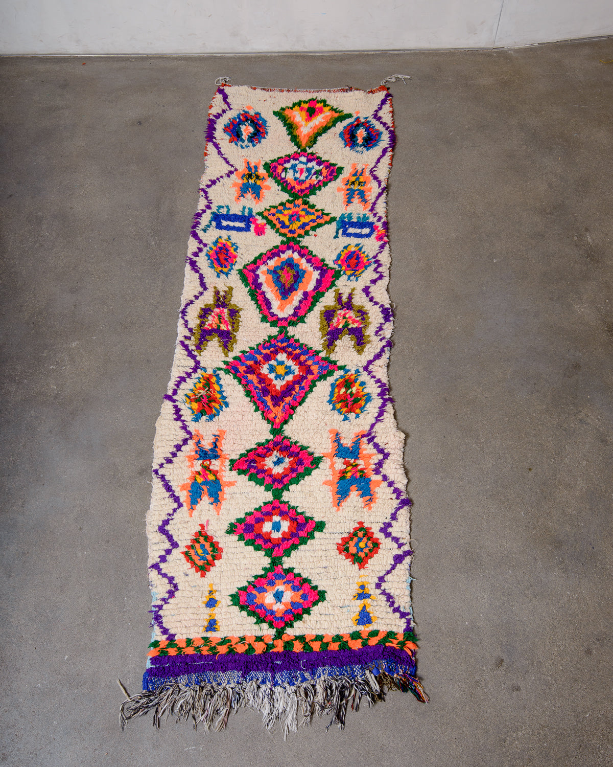 Modern designer vintage handcrafted Berber rug from Morocco. Boucherouite runner rug with beautiful colors and patterns.
